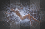 Woman lying in a sparkly spider web