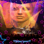 britney spears in concert with colorful backgrounds, stars, and light 